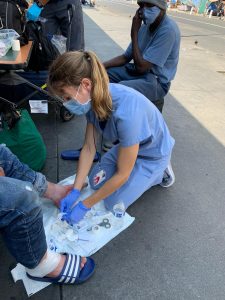 An LACHC street provider gives wound care in the field.